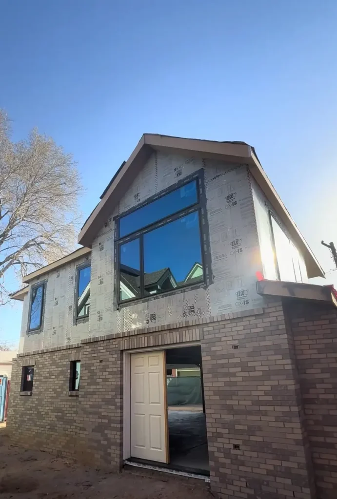 Denver home remodeling contractor upgrading brick exterior with new energy-efficient windows – Camerata Homes renovation project