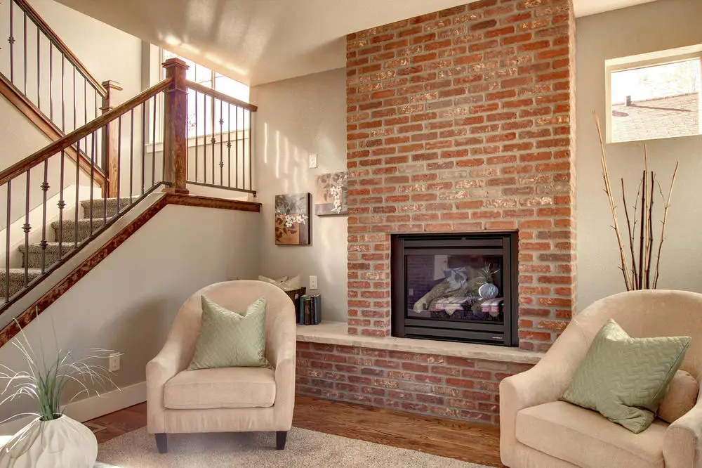 Custom-built Centennial home showcasing warm fireplace and elegant seating area