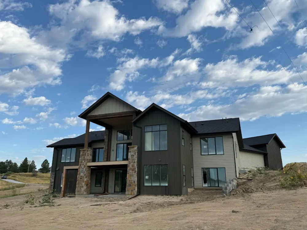 High-end home construction in Parker showcasing stone pillars and open layout